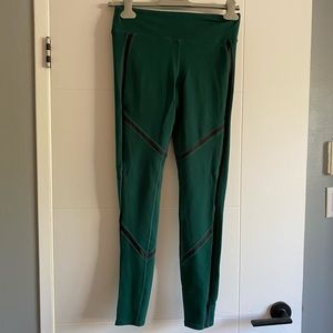 Green Alo leggings with black detailing